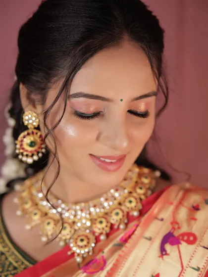A detailed shot of the glowing skin and soft pink eyeshadow.