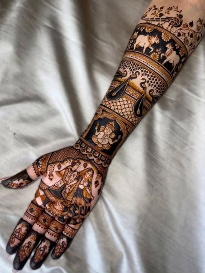A side view of our intricate bridal portrait mehandi. This angle highlights the detailed figures of the couple, Lord Ganesha, and the bands of elephants and swans that wrap around the arm.