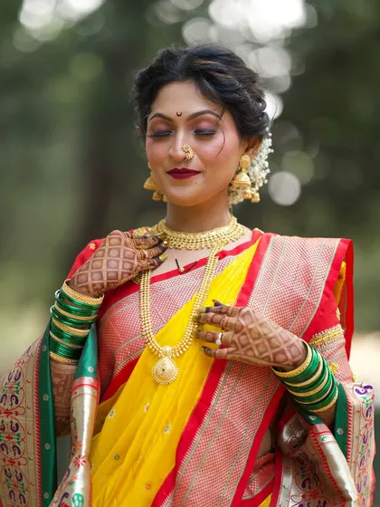 A classic Maharashtrian bridal look featuring a bold lip and soft, shimmering eyes. The traditional jewelry and gajra complete this timeless style, perfect for the main wedding ceremony.