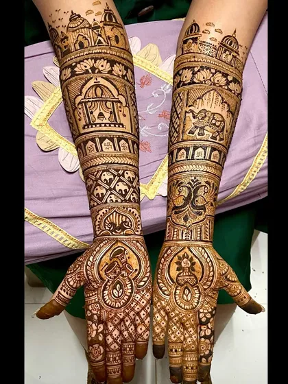 A grand design featuring palace architecture at the top, with elephants, paisleys, and other traditional patterns filling the arms.