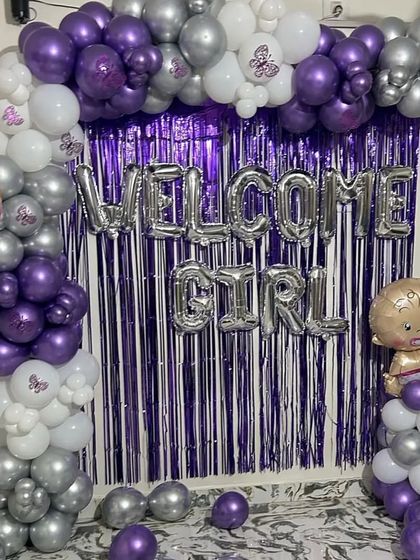 A 'Welcome Girl' decoration setup with a purple and silver theme, perfect for celebrating the arrival of a new baby.
