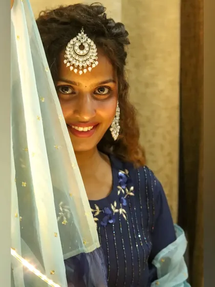 A close-up of the festive look, showing the intricate details on the kurta and the beautiful statement jewelry. I can help you find the perfect accessories to complete your festive outfit ideas.