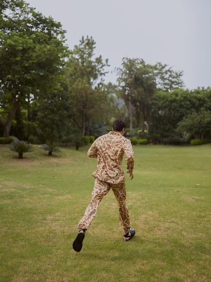An action shot of Ishwak Singh for Hindustan Times, captured mid-stride while running across a lawn.
