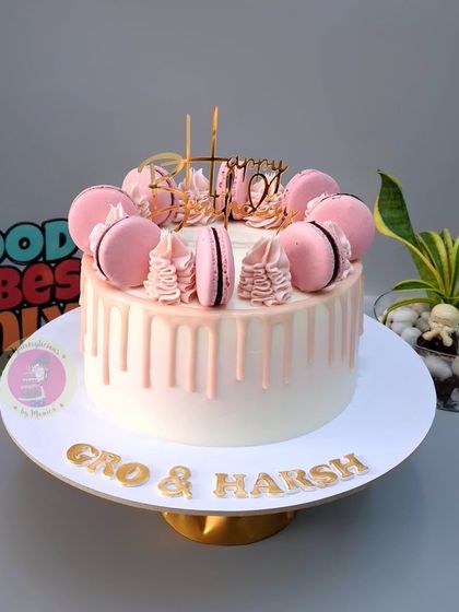 A beautiful pink drip cake with macarons, which traveled all the way to Hong Kong for a celebration.