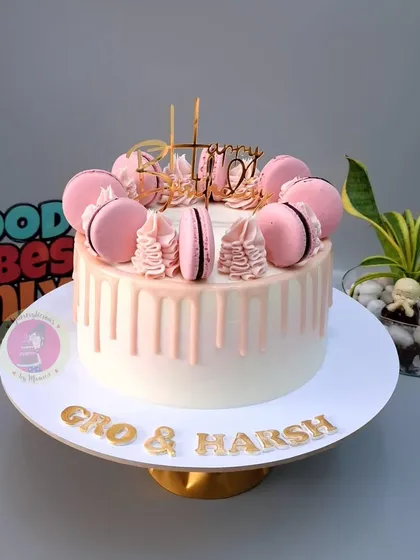 A beautiful pink drip cake with macarons, which traveled all the way to Hong Kong for a celebration.