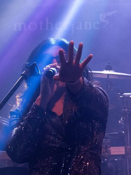 A dramatic shot from our opening act for the legendary band Motherjane. The stage lights and smoke create a powerful atmosphere, highlighting the intensity of our performance.