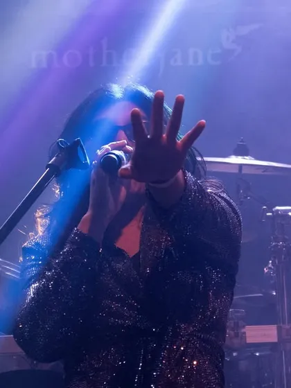 A dramatic shot from our opening act for the legendary band Motherjane. The stage lights and smoke create a powerful atmosphere, highlighting the intensity of our performance.