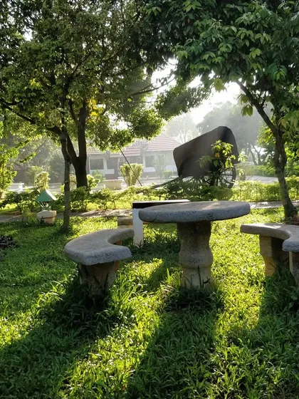 A serene sunrise at our retreat. This stone seating area in the garden is a perfect spot to welcome the new day, meditate, or simply enjoy the golden morning light.