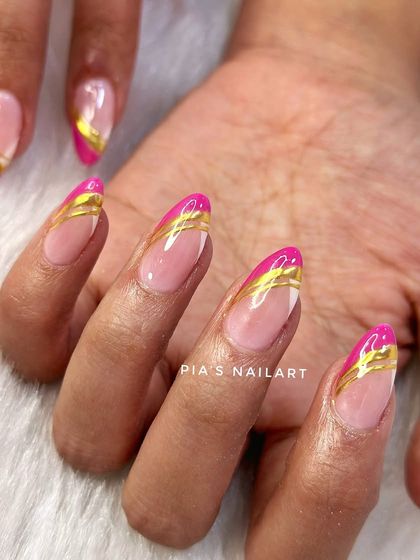 A vibrant pink French tip with elegant gold chrome details. A fun and colorful way to update a classic style.