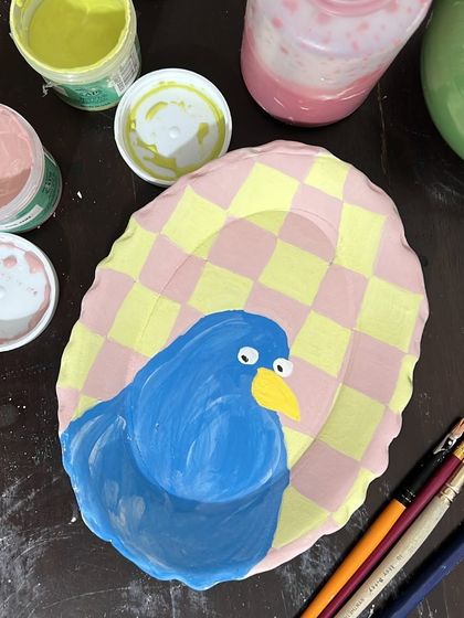 I have fun drawing pigeons with weird expressions. This hand-built stoneware plate features a rather skeptical-looking blue pigeon against a cheerful checkered background.