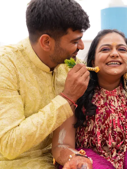 A playful moment from the Haldi ceremony, with the brother of the bride in a cheerful yellow kurta. We curate looks for every event, ensuring the family's style is consistent and celebratory.