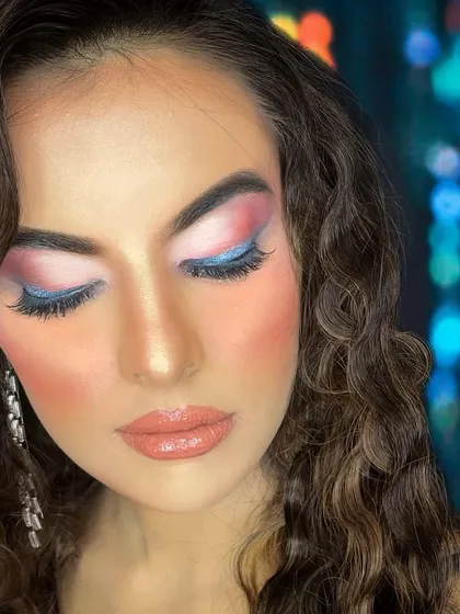 A beautiful evening glam look with a soft blend of pink and blue eyeshadow, perfect for a party or special occasion.