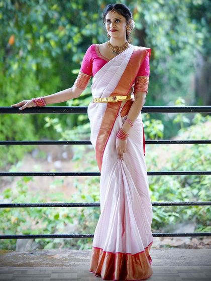 A full-length view of the timeless white and pink saree combination, perfect for pre-wedding ceremonies or festive events.