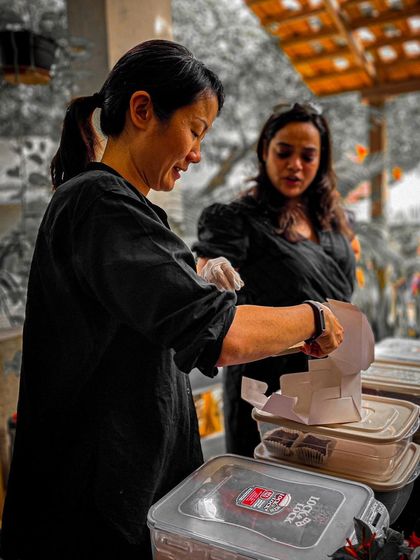 Our food partners carefully preparing delicious treats for the attendees. Good food is a key part of the Garage Sale experience.