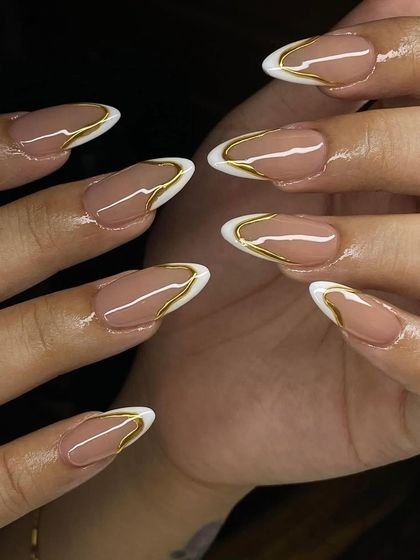 A modern take on the French manicure with a double outline in white and gold. This is a very sophisticated and trendy look.