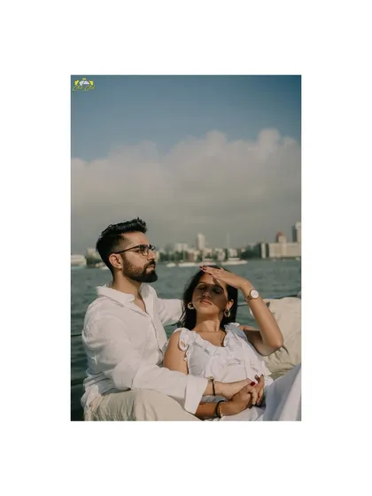 A vertical portrait of the couple enjoying the sun and sea on their yacht in Mumbai.