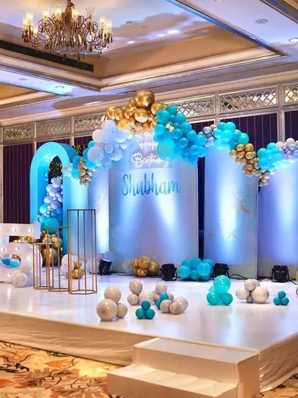 The full stage for the 15th birthday, featuring a clean white platform, elegant arches, and marquee numbers.