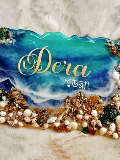 This custom ocean-themed nameplate brings the calm and beauty of the sea right to your doorstep. I used real seashells and sand with flowing resin waves to create a piece that feels both personal and serene, making for a truly unique welcome.