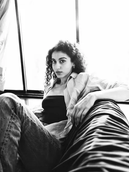 A low-angle black and white shot that feels powerful and confident. The high-contrast lighting adds to the dramatic mood.