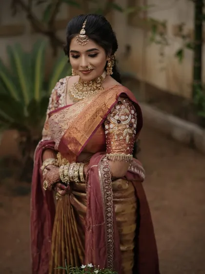 A candid shot of the bride, her soft makeup and traditional jewellery looking elegant.