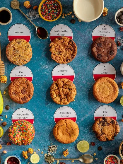 A creative and colorful flatlay for Siaa Desert Bakery's cookie menu. This organized composition not only displays the variety of flavors but also deconstructs them with surrounding ingredients, making it both informative and visually engaging for customers.