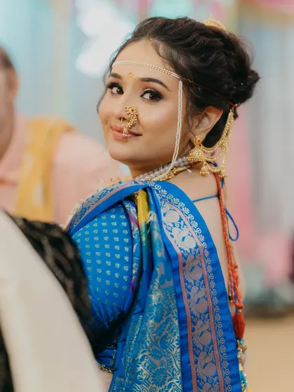 A candid shot of my beautiful bride Niharika. The side profile shows the elegant hairstyle and the traditional mundavalya, essential parts of the Maharashtrian bridal look.