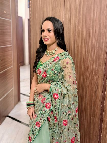 A client in a green floral saree.