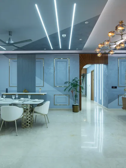 This dining space at SNN Clermont blends minimalist design with modern classic elements. Soft blue walls with gold trim create a calm yet elegant base.