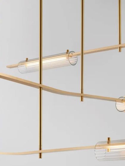 A detailed shot of the Volant system with a brass finish and clear glass, highlighting the precision of its machined components.