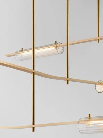 A detailed shot of the Volant system with a brass finish and clear glass, highlighting the precision of its machined components.