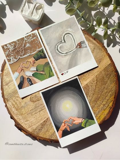 A set of three polaroid paintings celebrating love. These gouache illustrations show different ways of expressing affection, from making hearts with hands on the beach to a simple heart drawn in the snow.