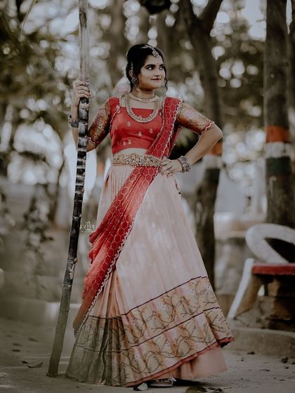 For the Makara Sankranthi festival, I designed this exquisite Zari Kota lehenga for my client. The peach skirt with a traditional border is paired with a red brocade blouse, creating a vision of grace and tradition.