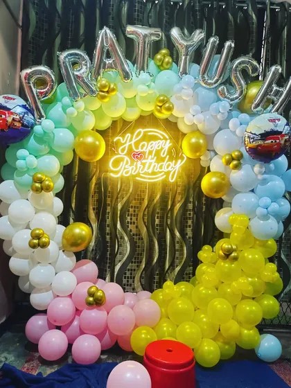A colorful Cars movie themed birthday party. The balloon ring uses multiple colors, and I've added Lightning McQueen foil balloons to bring the theme to life.