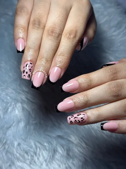 Another look at this classy yet wild design with black French tips and leopard print accents.