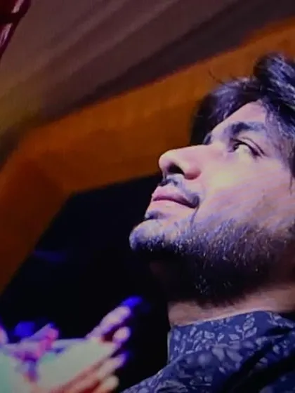A candid shot during a Zitar performance in Ahmedabad, capturing a moment of deep focus.