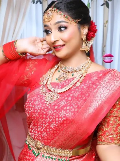 Another angle of this beautiful South Indian bridal look, showing the details of the embroidered blouse, the layered necklaces, and the fresh flowers in her hair.