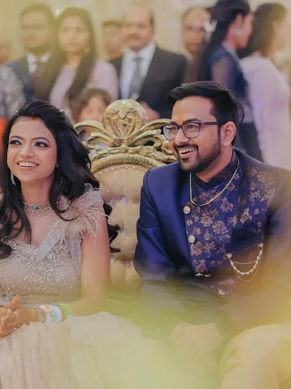 Candid smiles from the couple as they enjoy their ceremony from the main stage. These relaxed moments are often the most genuine.