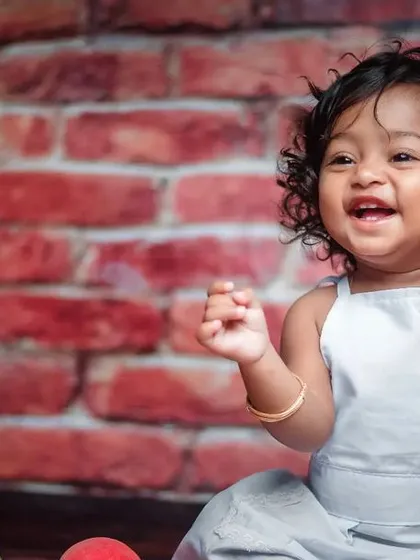 Look at that happy smile. Milestone sessions are all about fun, and my 'Little Chef' theme is a perfect example. We get a little messy with some flour and capture your baby's budding personality in a playful studio setting.