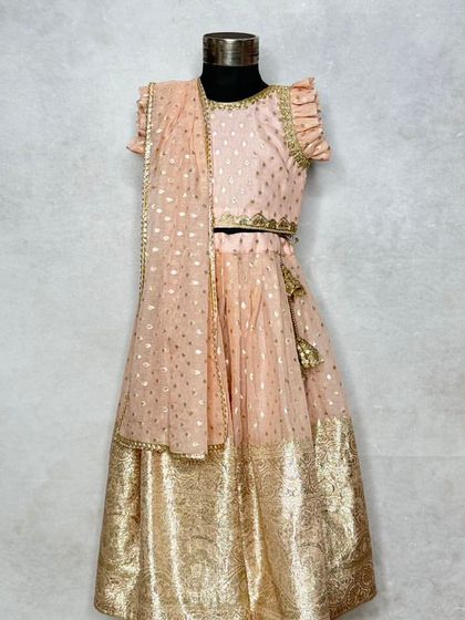 A slightly different angle of the periwinkle lehenga, highlighting the delicate tassels on the skirt tie.