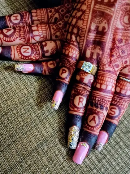 The details matter. This shows a beautiful bridal nail extension with custom art, a perfect finishing touch to complete the bride's look.