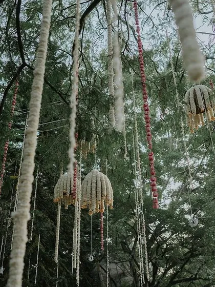 A close-up of the hanging floral decor, featuring jasmine bells and other traditional elements.