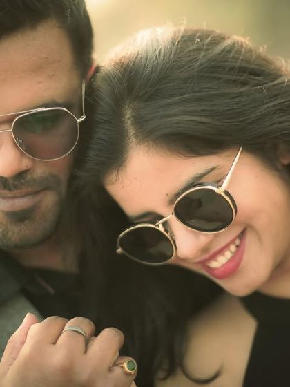 A happy and stylish close-up of a couple, capturing their smiles and modern aesthetic during an outdoor pre-wedding shoot.