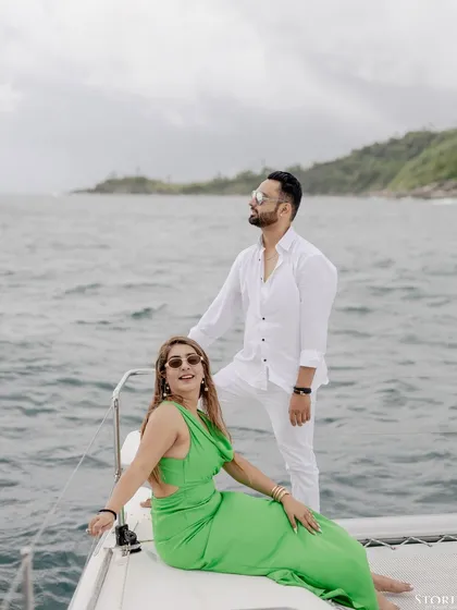 Another stunning shot of the couple on the yacht, capturing the wind and the endless ocean.