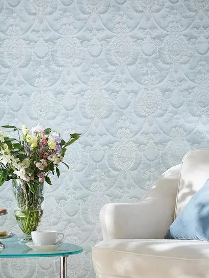 A delicate, embossed damask pattern in a pale blue. The texture adds a subtle shimmer and a tactile quality, creating a serene and high-end feel.