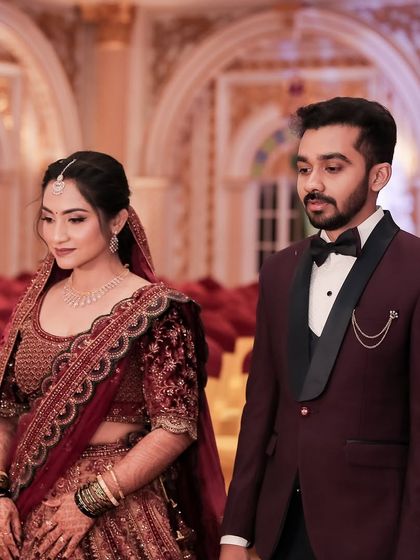 A candid moment between the couple. The bride's makeup looks flawless from the side, with a beautifully blended contour and a soft glow.