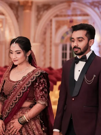 A candid moment between the couple. The bride's makeup looks flawless from the side, with a beautifully blended contour and a soft glow.