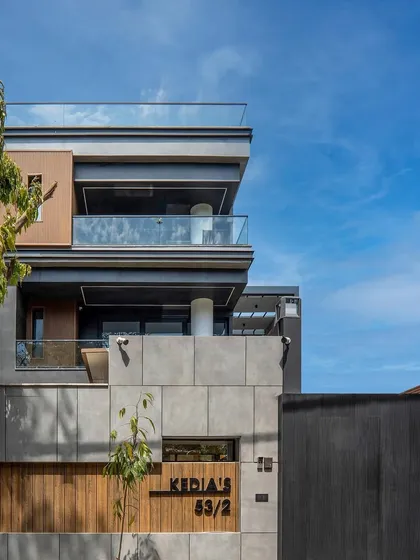 Our completed design and build residence in East Punjabi Bagh. The façade combines concrete, wood paneling, and clean lines for a modern and understated look.