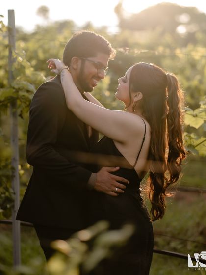 A golden hour portrait of a couple in a Khao Yai vineyard. The warm, soft light and their gentle embrace create a deeply romantic and cinematic pre-wedding photograph.