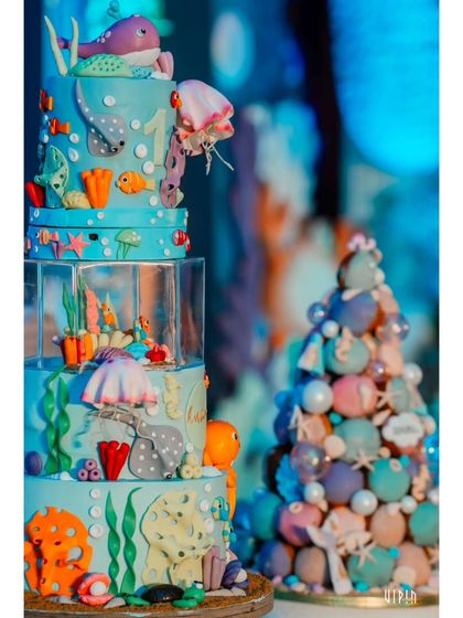 The spectacular 'Under the Sea' themed cake, featuring multiple tiers of ocean life, from an octopus and stingray to colorful fish and coral. It's a true work of edible art.