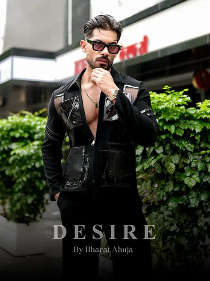 A full-body shot that showcases the unique design of the black utility shirt. It's a statement of confidence and modern luxury.